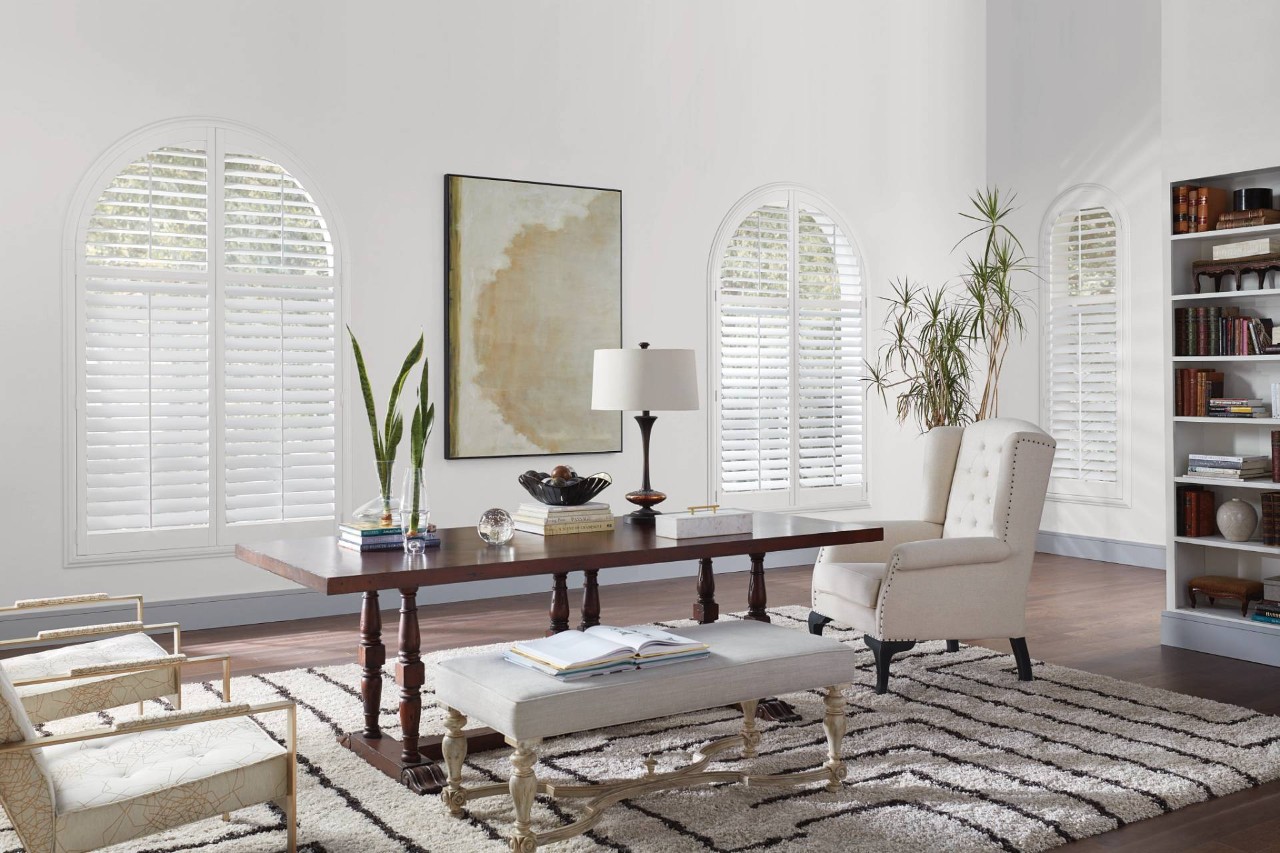 Hunter Douglas Newstyle® Hybrid Shutters adorning a stylish living room near Denver, CO