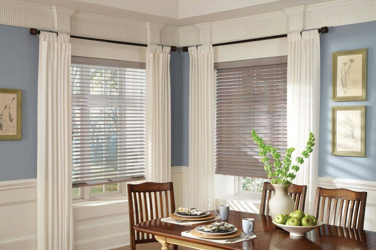 Brown Hunter Douglas Parkland® Wood Blinds hanging on kitchen windows near Denver, CO